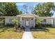 Inviting entryway with columns, decorative plants, and a welcoming sign, creating a warm ambiance at 2410 Nw Avenue B, Winter Haven, FL 33880