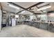 Spacious workshop area with ample counter space, shelving, and lighting for various projects at 4910 Loch Ness Dr, Lakeland, FL 33810