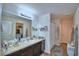 Bathroom featuring granite countertop, framed mirror, and stylish accents at 6286 Manitoba Dr, Lakeland, FL 33805
