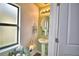 Charming half bathroom with stylish fixtures, a pedestal sink, and natural light at 6286 Manitoba Dr, Lakeland, FL 33805