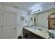 Bathroom featuring granite countertop, framed mirror, and stylish accents at 6286 Manitoba Dr, Lakeland, FL 33805