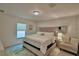 Bright bedroom with a tufted headboard bed, soft rug, and natural light from the window at 6286 Manitoba Dr, Lakeland, FL 33805