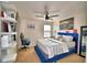 Bedroom featuring decoratively placed furniture, a ceiling fan, and a large window at 6286 Manitoba Dr, Lakeland, FL 33805