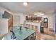 Cozy dining area next to the kitchen, featuring a glass table, modern chairs, and bar stool seating at 6286 Manitoba Dr, Lakeland, FL 33805