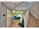 Inviting foyer with staircase and an open view into the living area, showcasing modern design at 6286 Manitoba Dr, Lakeland, FL 33805