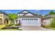 Charming two-story home featuring a large garage with classic design elements and manicured landscaping at 6286 Manitoba Dr, Lakeland, FL 33805