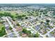 A beautiful aerial view of homes surrounded by trees and a small pond in a neighborhood at 7968 Charleston Blvd, Lakeland, FL 33810