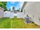 The backyard features a well-maintained lawn and a white privacy fence with an open gate at 7968 Charleston Blvd, Lakeland, FL 33810