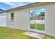 Exterior of home with backyard grass and sliding glass door at 7968 Charleston Blvd, Lakeland, FL 33810