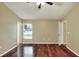 Spacious bedroom featuring hardwood floors, neutral walls, and natural light from a bright window at 7968 Charleston Blvd, Lakeland, FL 33810