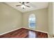 Bedroom with a ceiling fan, hardwood floors, and a bright window at 7968 Charleston Blvd, Lakeland, FL 33810