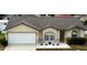 Inviting single-story home featuring a well-kept front yard and a two-car garage at 7968 Charleston Blvd, Lakeland, FL 33810
