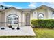 Charming single-story home with an inviting entrance and fresh landscaping at 7968 Charleston Blvd, Lakeland, FL 33810
