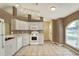 Well-lit kitchen featuring ample counter space, white appliances, and tile floors, great for cooking at 7968 Charleston Blvd, Lakeland, FL 33810