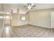 Spacious living room with tile flooring, a ceiling fan, and an open layout perfect for entertaining at 7968 Charleston Blvd, Lakeland, FL 33810
