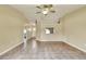 Open-concept living room with tile flooring, a ceiling fan, and ample natural light at 7968 Charleston Blvd, Lakeland, FL 33810