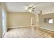 Open-concept living room with tile floors, a ceiling fan, and a high ceiling, offering a spacious feel at 7968 Charleston Blvd, Lakeland, FL 33810
