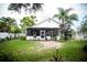 Charming backyard featuring a screened patio, lush greenery, and a well-maintained lawn, ideal for outdoor enjoyment at 811 W Heron Pl, Winter Haven, FL 33884