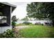 Spacious backyard features a well-kept lawn, mature trees, and a privacy fence, ideal for outdoor living and entertaining at 811 W Heron Pl, Winter Haven, FL 33884
