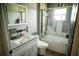 Bathroom features a white single sink vanity with gray countertops and a shower-tub combo at 811 W Heron Pl, Winter Haven, FL 33884