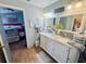 Bathroom featuring double sink vanity, granite counters, and framed mirrors at 811 W Heron Pl, Winter Haven, FL 33884