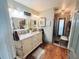 Elegant bathroom featuring double sinks, granite countertops, and a glass-enclosed shower at 811 W Heron Pl, Winter Haven, FL 33884