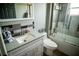 Bathroom featuring a white single sink vanity with gray countertops and a shower-tub combo at 811 W Heron Pl, Winter Haven, FL 33884