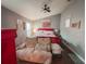 Comfortable bedroom with a ceiling fan, ample natural light, and cozy seating at 811 W Heron Pl, Winter Haven, FL 33884