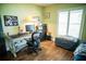 Bright bedroom with a workspace featuring a large window, desk, and modern office chair at 811 W Heron Pl, Winter Haven, FL 33884