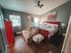 Cozy bedroom with hardwood floors, two windows for natural light, and comfortable seating at 811 W Heron Pl, Winter Haven, FL 33884