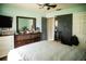 View of a bedroom with a ceiling fan, gray bedding, and a dark-brown dresser at 811 W Heron Pl, Winter Haven, FL 33884