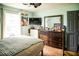 View of a bedroom with white trim and blue-painted walls and a light-brown floor at 811 W Heron Pl, Winter Haven, FL 33884