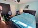 Cozy bedroom featuring a large bed, ceiling fan, and dark accent wall at 811 W Heron Pl, Winter Haven, FL 33884