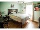 Bright bedroom featuring hardwood floors, and a large bed at 811 W Heron Pl, Winter Haven, FL 33884