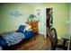 Small bedroom with an open closet and wooden dresser offering ample storage solutions at 811 W Heron Pl, Winter Haven, FL 33884