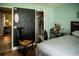 View of a bedroom with a chalkboard wall, closet, and wood floor at 811 W Heron Pl, Winter Haven, FL 33884