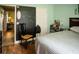 View of a bedroom with a chalkboard wall and light-blue painted walls and wood floor at 811 W Heron Pl, Winter Haven, FL 33884