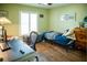 Well-lit bedroom with a desk, window, and hardwood floors at 811 W Heron Pl, Winter Haven, FL 33884