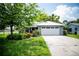 Charming single-story home with a well-manicured lawn and a two car garage in a quiet neighborhood at 811 W Heron Pl, Winter Haven, FL 33884