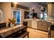 Spacious kitchen with island seating, modern lighting, tile flooring, and contemporary appliances at 811 W Heron Pl, Winter Haven, FL 33884