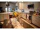 Modern kitchen featuring stainless steel appliances, light gray cabinets, and a beautiful backsplash at 811 W Heron Pl, Winter Haven, FL 33884