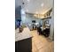Open-concept kitchen with modern lighting, stainless steel appliances and a view of the dining area at 811 W Heron Pl, Winter Haven, FL 33884