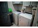 Efficient laundry room with gray cabinetry and modern washer and dryer set, offering convenience and functionality at 811 W Heron Pl, Winter Haven, FL 33884