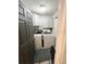 Convenient laundry room with white cabinets, gray walls, and gray door at 811 W Heron Pl, Winter Haven, FL 33884