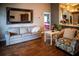 Charming living room featuring hardwood floors, a neutral-toned sofa, and an open doorway to the kitchen at 811 W Heron Pl, Winter Haven, FL 33884