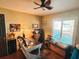 Office room with a ceiling fan, window with blinds, a wooden desk and chair at 811 W Heron Pl, Winter Haven, FL 33884