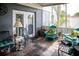 Covered porch with flagstone floors and outdoor furniture, perfect for relaxing outdoors at 811 W Heron Pl, Winter Haven, FL 33884