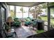 Covered porch with flagstone floors, outdoor furniture, and views of the backyard at 811 W Heron Pl, Winter Haven, FL 33884