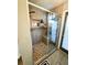 Tiled shower with glass door and built-in bench seating, showcasing a modern design at 811 W Heron Pl, Winter Haven, FL 33884