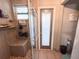 Tiled shower featuring clear glass door, overhead shower and built-in bench seating at 811 W Heron Pl, Winter Haven, FL 33884